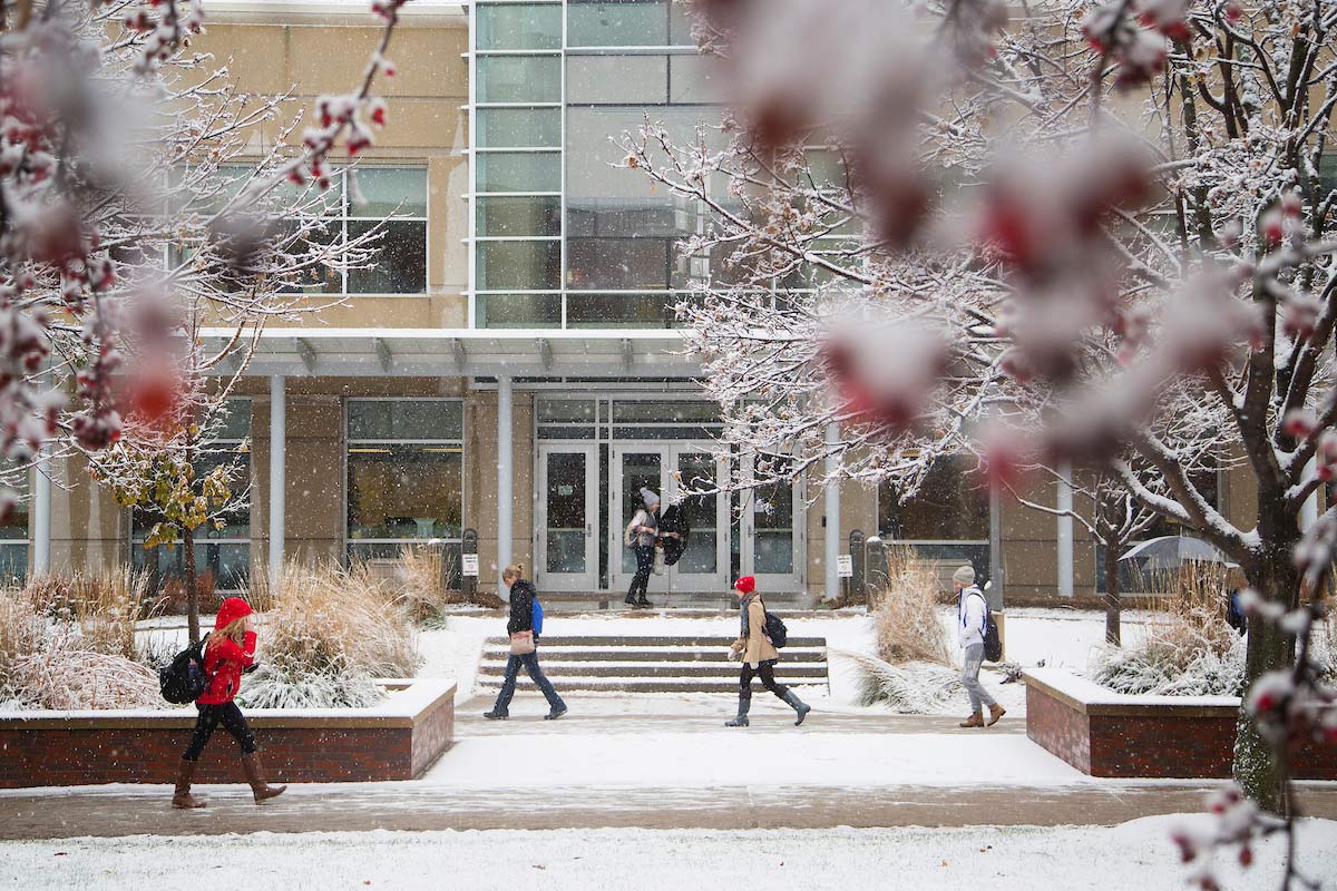 students walking on campus in snowy weather