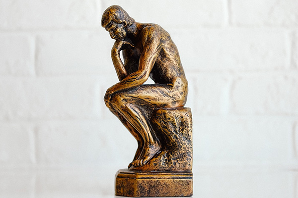 a small statue of the thinker
