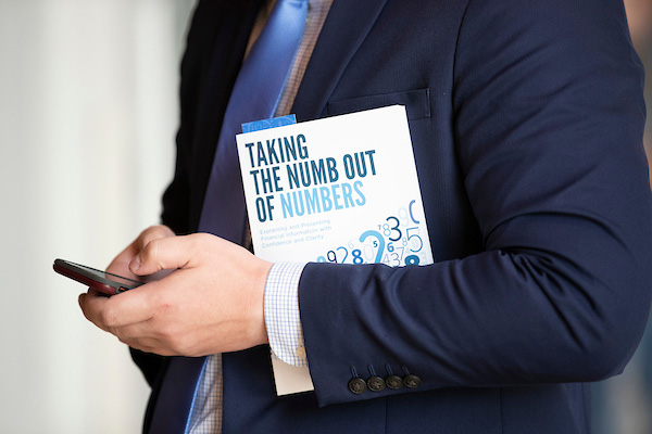 a student holds a book called taking the numb out of numbers
