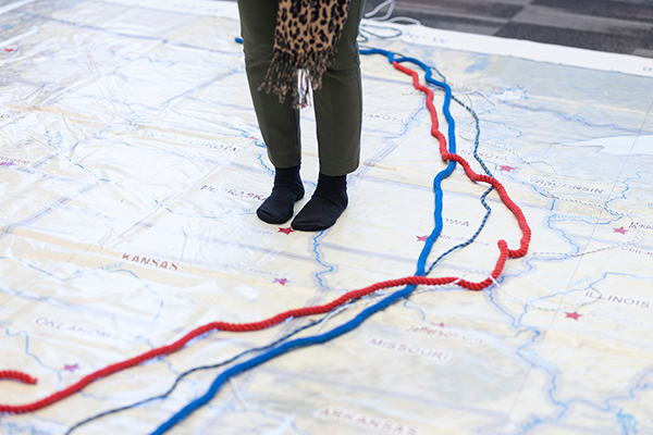 a woman stands on a huge map of the midwest