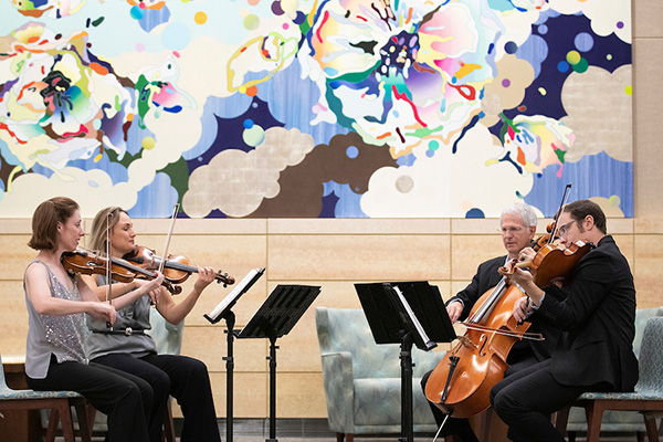 a group of doctors plays in a string quartet at unmc
