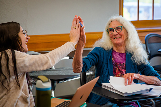 UNO Creative Nonfiction Writing students giving high fives in the classroom