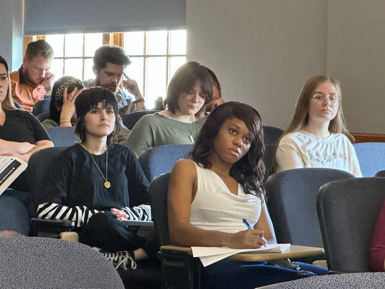 TATP Students taking notes while listening to a presentation