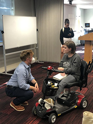 Author Taylor Brorby talking to a student