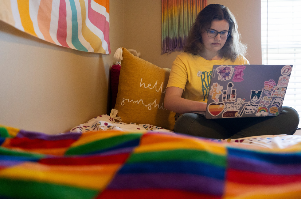 A student working on a laptop. 