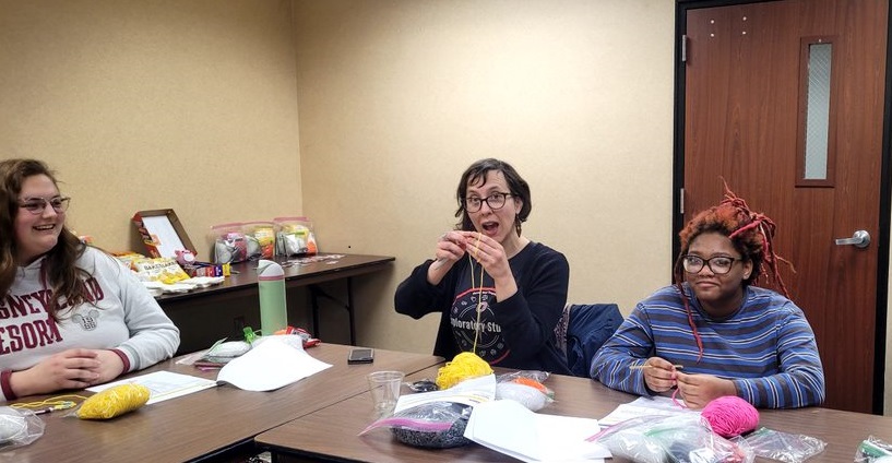 Picture of three EXPL team members crocheting.