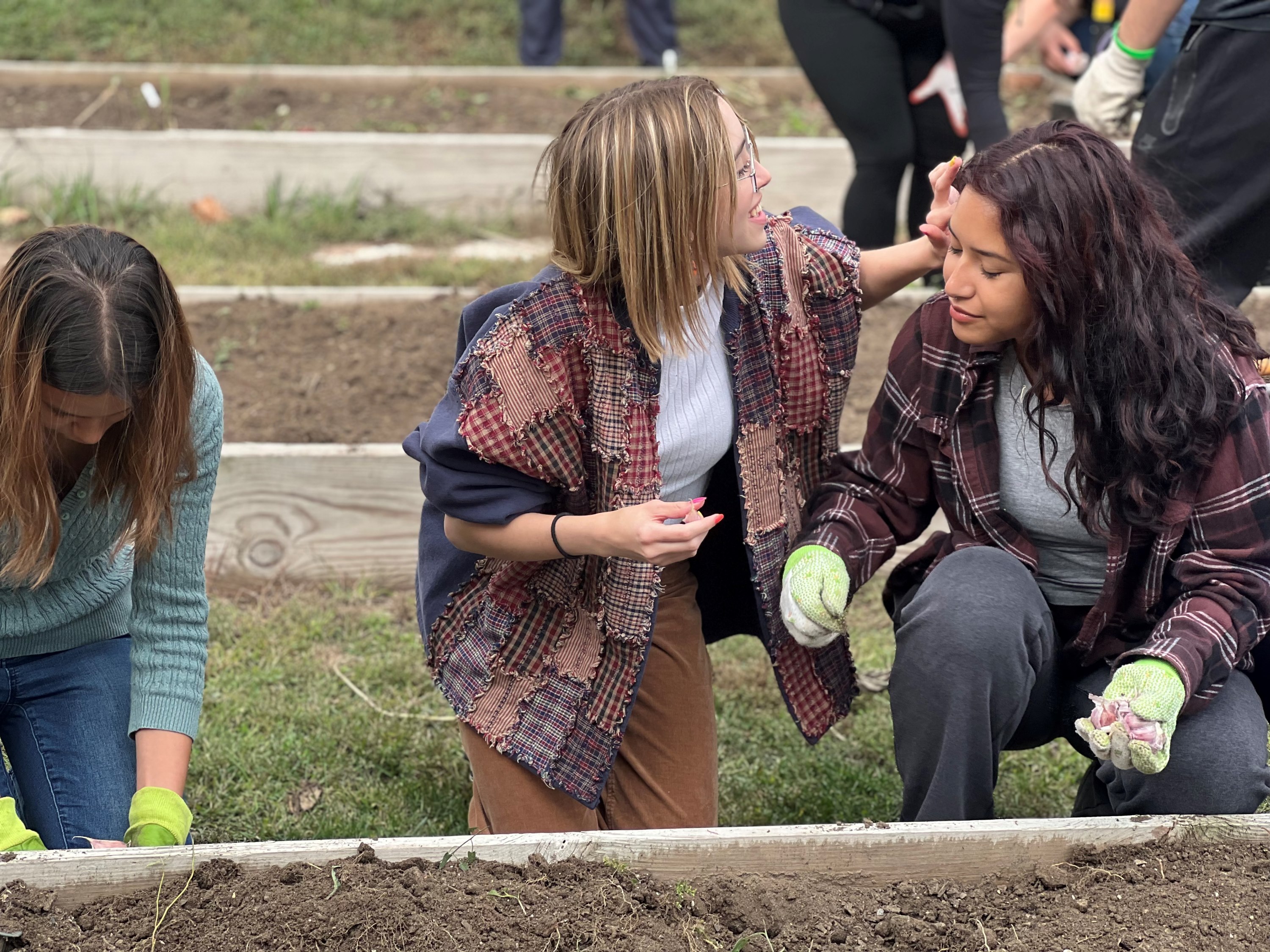 Explorers socializing over gardening during one of our trips to Together Inc.