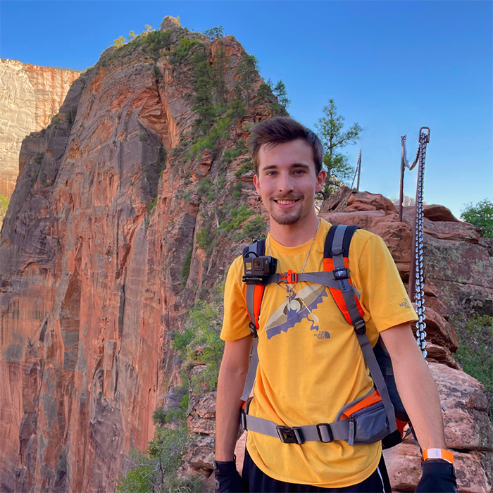 Josh smiles while out on a hike. 