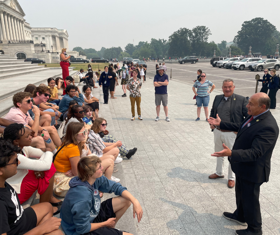 Members of Congress chat with NCLP students on the steps of the U.S. Capitol. 