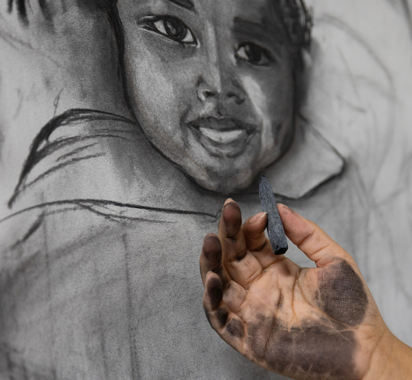 a charcoal image of a little girl