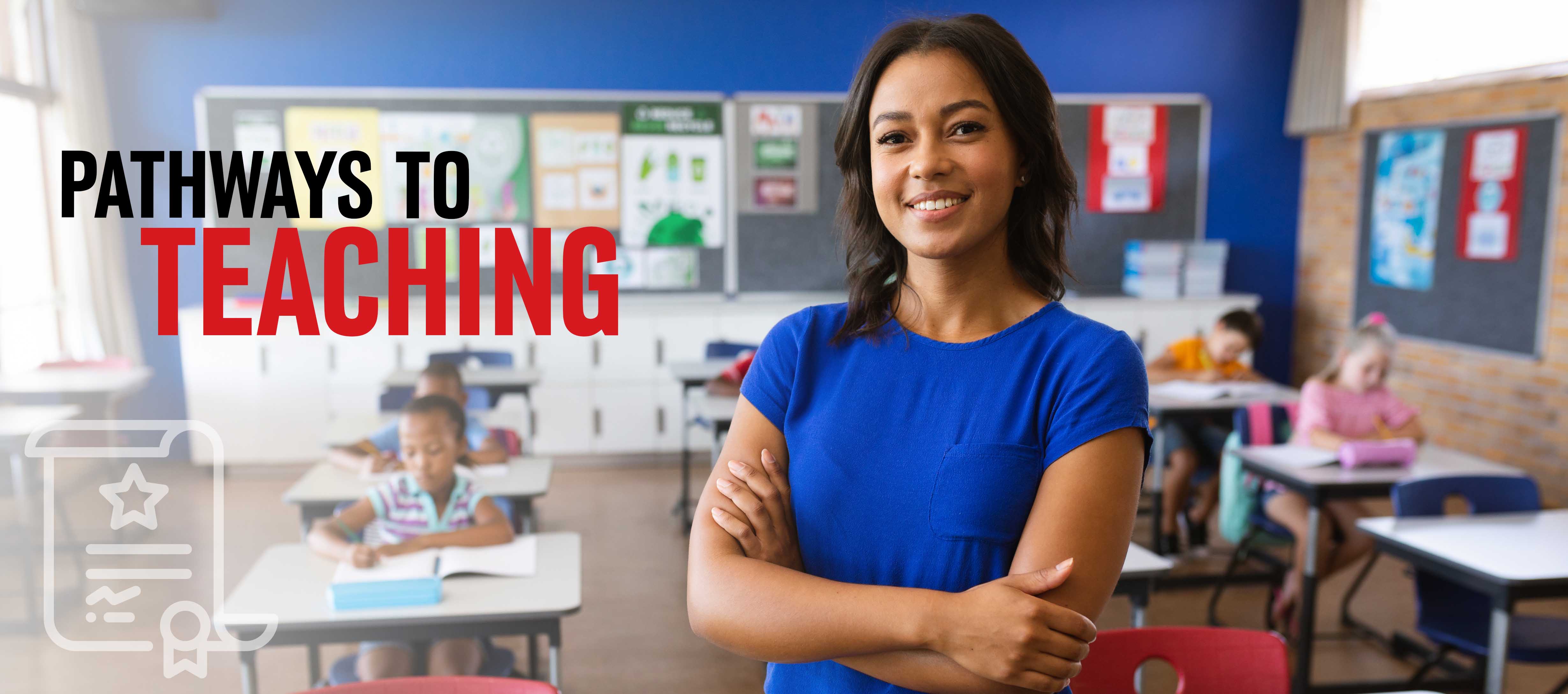 A teacher stands in her classroom with students at desks in the background