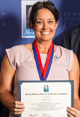 Woman poses for a photo holding a certificate