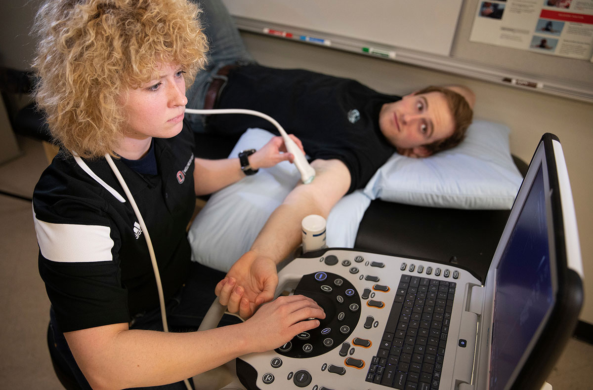 A person lies down in a lab and gets an ultrasound