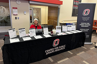 Community Service Specialist Dena Lund showcasing CPAR's work at the UNO College of Public Affairs and Community Service Open House