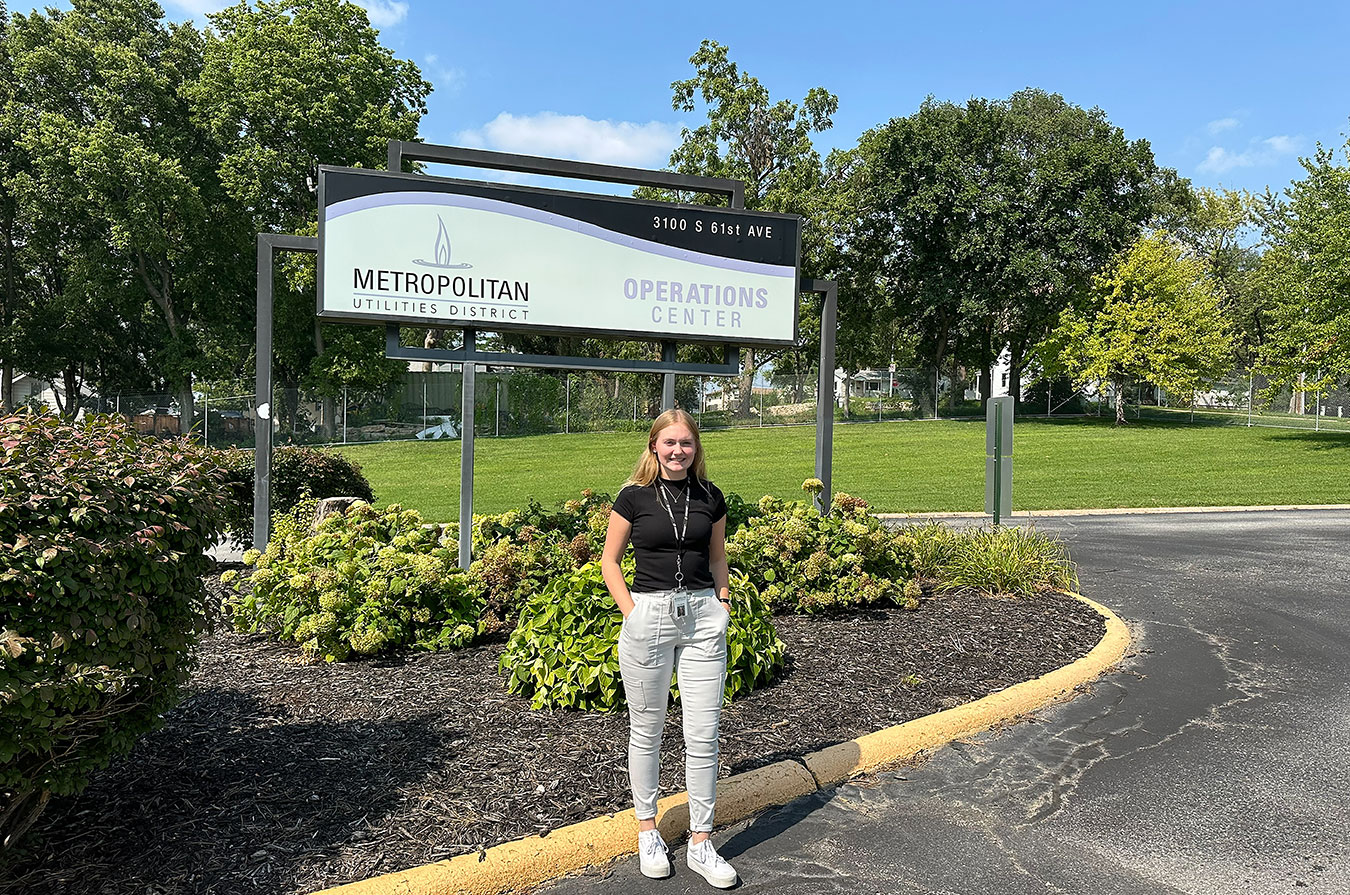 emds student in in front of building with trees