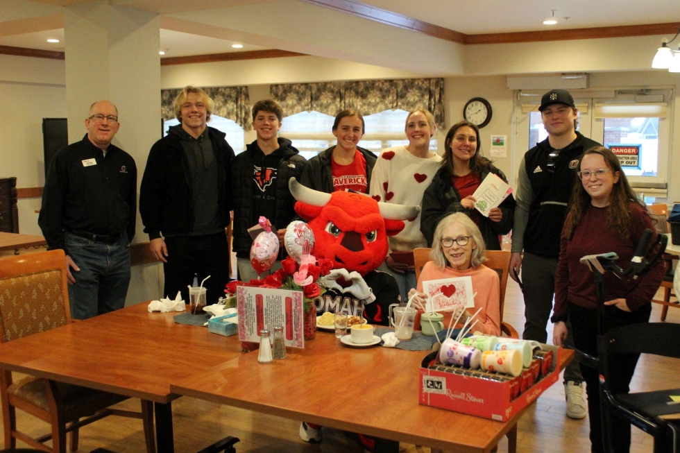 Group of students and UNO mascot delivering valentines to a nursing home