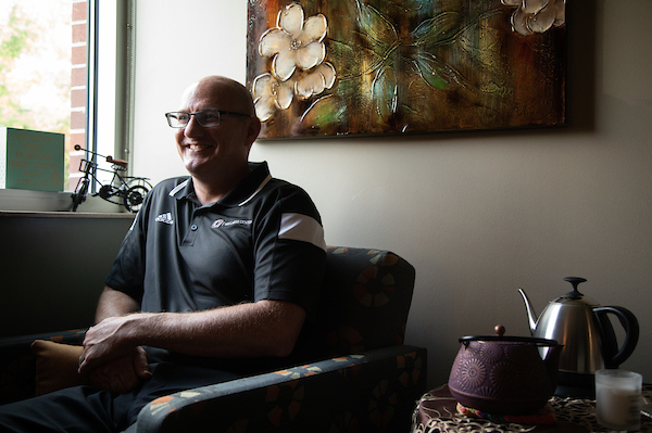 nate bock sits in his CAPS office