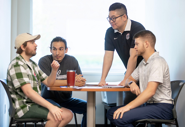 a group of people sits at a table and chats