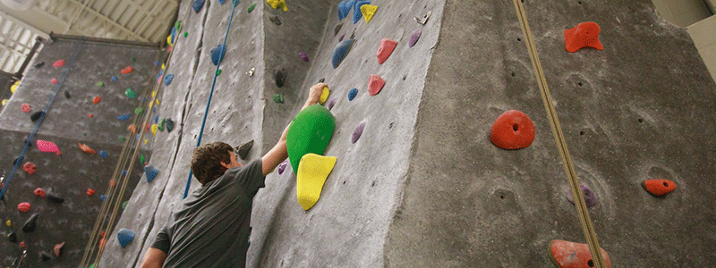 a man climbs a rock wall