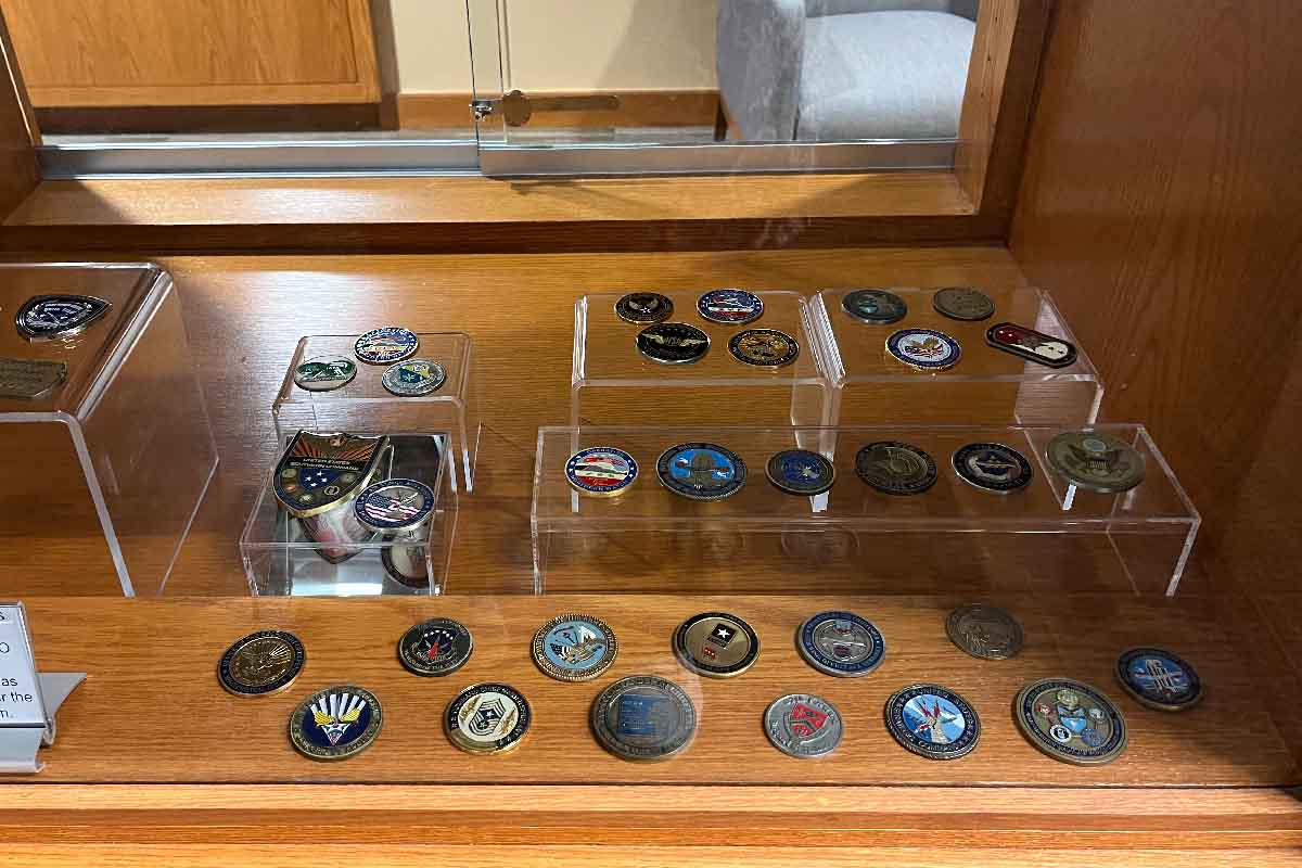wooden shelves with various medals on them