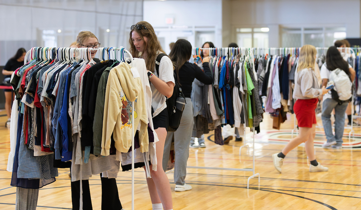 Many students in a gym with Durango's Outfitters clothing, shopping, and checking out