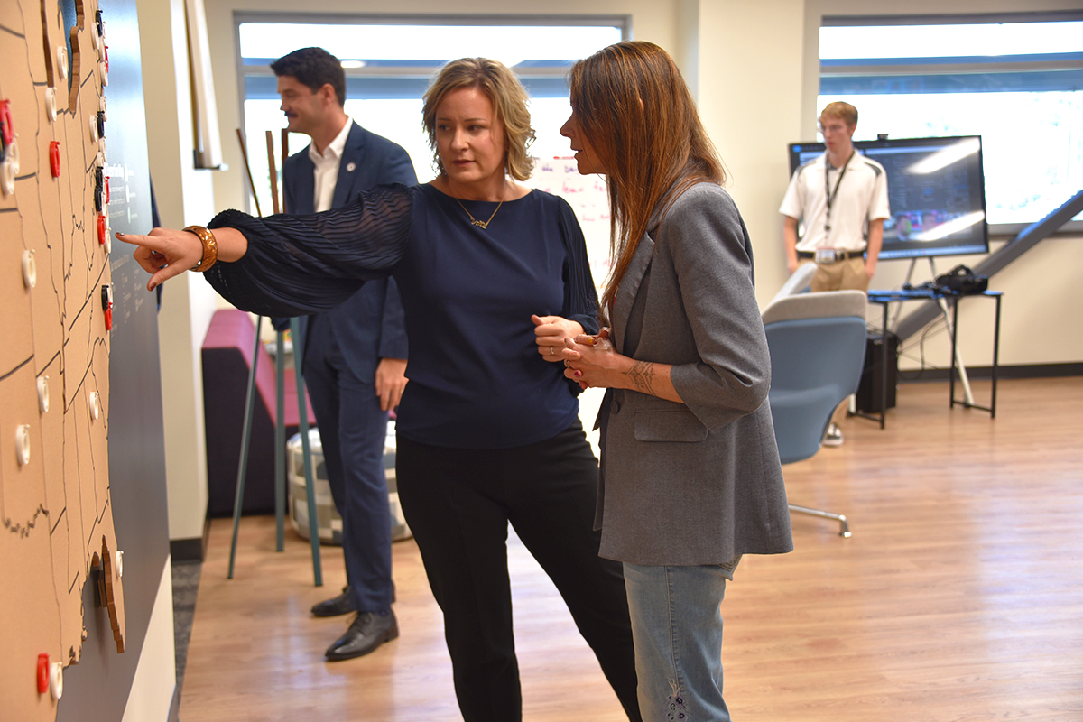 Gina Ligon shows Jen Easterly the NCITE Consortium Map.