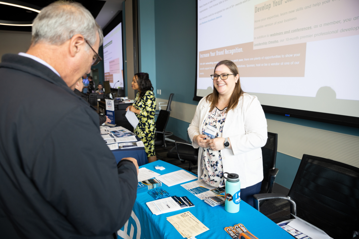 Attendees meet with an agency representative at their booth.