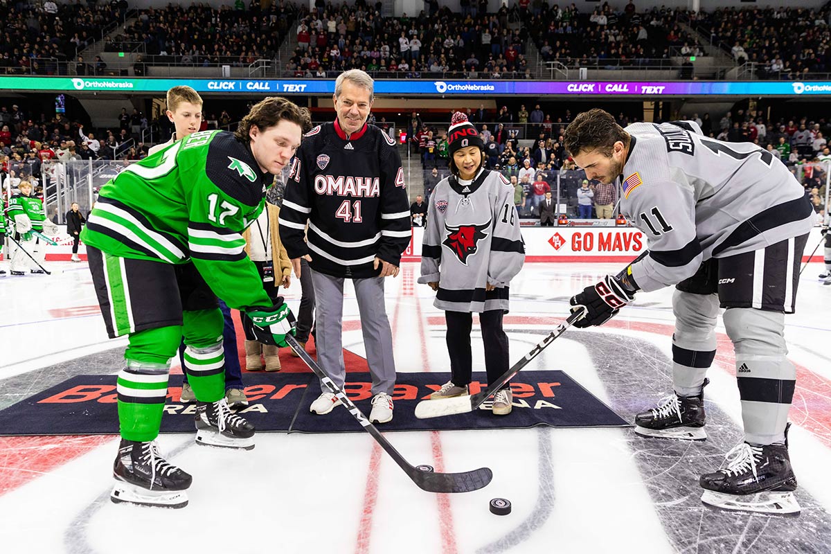 ceremonial first puck drop with Nebraska Governor Jim Pillen and UNO Chancellor Joanne Li, Ph.D., CFA.