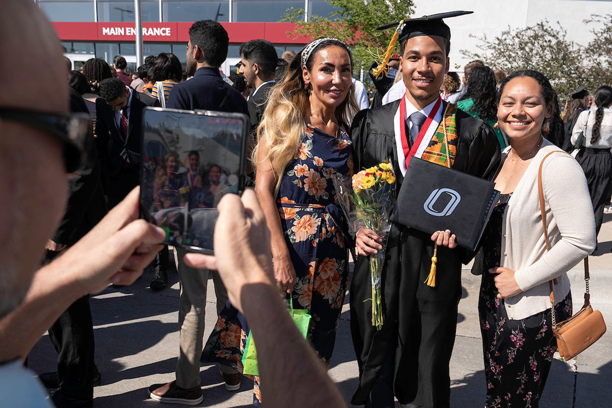 Student celebrating with loved ones after Commencement