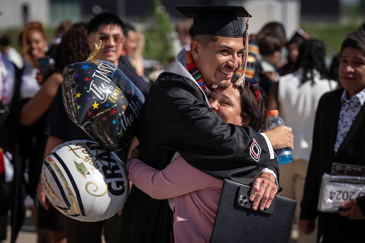 graduate celebrating with loved ones