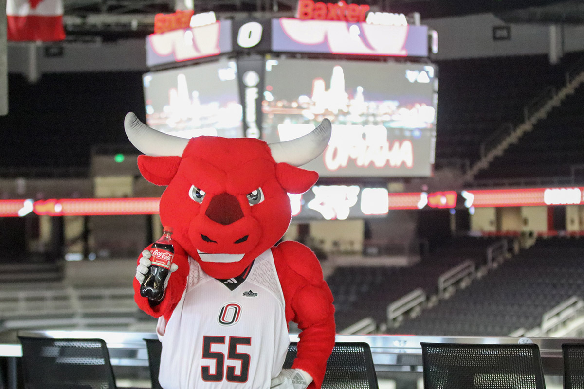 Durango at Baxter Arena holding a bottle of Coca-Cola