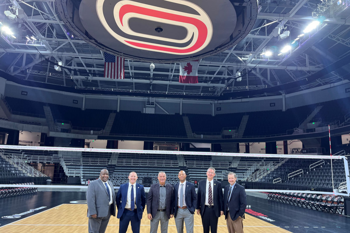 U.S. Rep. Don Bacon (center left) joined UNO Vice Chancellor and Director of Athletics Adrian Dowell (center right) on a visit to Baxter Arena.