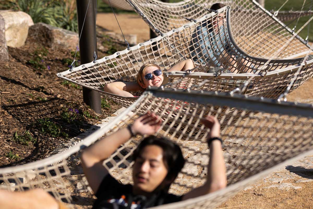 McCartney and Brandon are seen hanging out in hammocks on campus. 