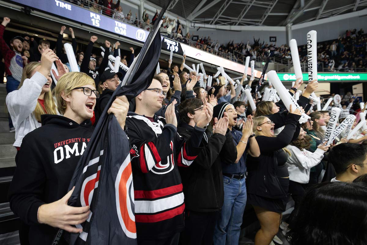 From left to right: McCartney, James, Derek, and Brandon are seen cheering on the Mavericks at an Omaha Hockey game. 