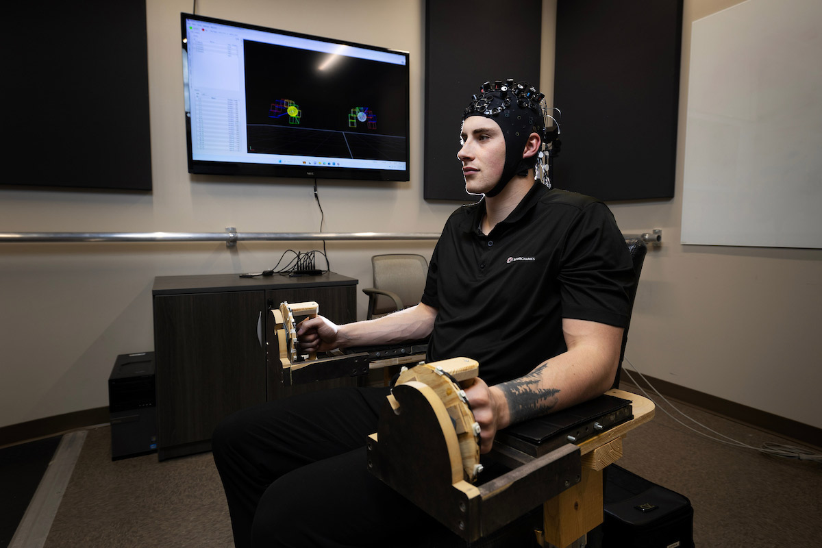 Doctoral Student Kolby Brink used a dining room chair from assistant dean Dr. Nick Stergiou to create a prototype for his research.