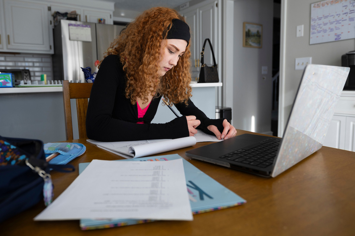 University of Nebraska at Omaha (UNO) College of Business Administration student and Army veteran Kaylin “Katie” Plaza studies at her kitchen table. Photo: Ryan Soderlin, UNO Office of Strategic Marketing and Communications.