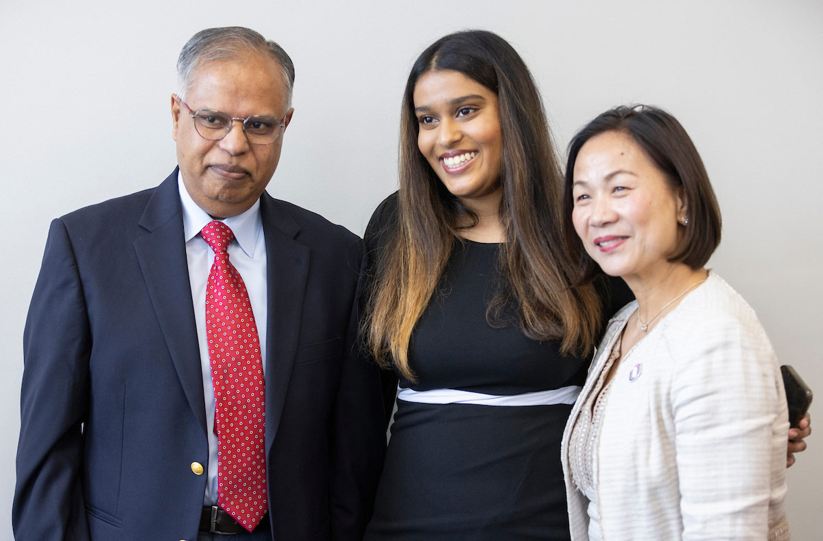 UNO Student Body President Ishani Adidam (center) takes a photo with her father, UNO Professor Phani Tej Adidam, Ph.D., (left) and UNO Chancellor Joanne Li, Ph.D., CFA, (right) at the Student Government Swearing In Ceremony.