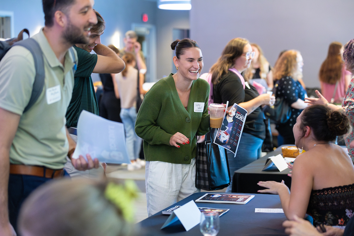 graduate students interact with Campus partners at their tables at the new graduate student welcome event