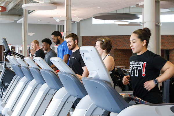 students running on treadmills in the wellness center on dodge campus