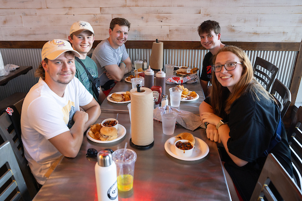 uno students eating food at a restaurant in aksarben village